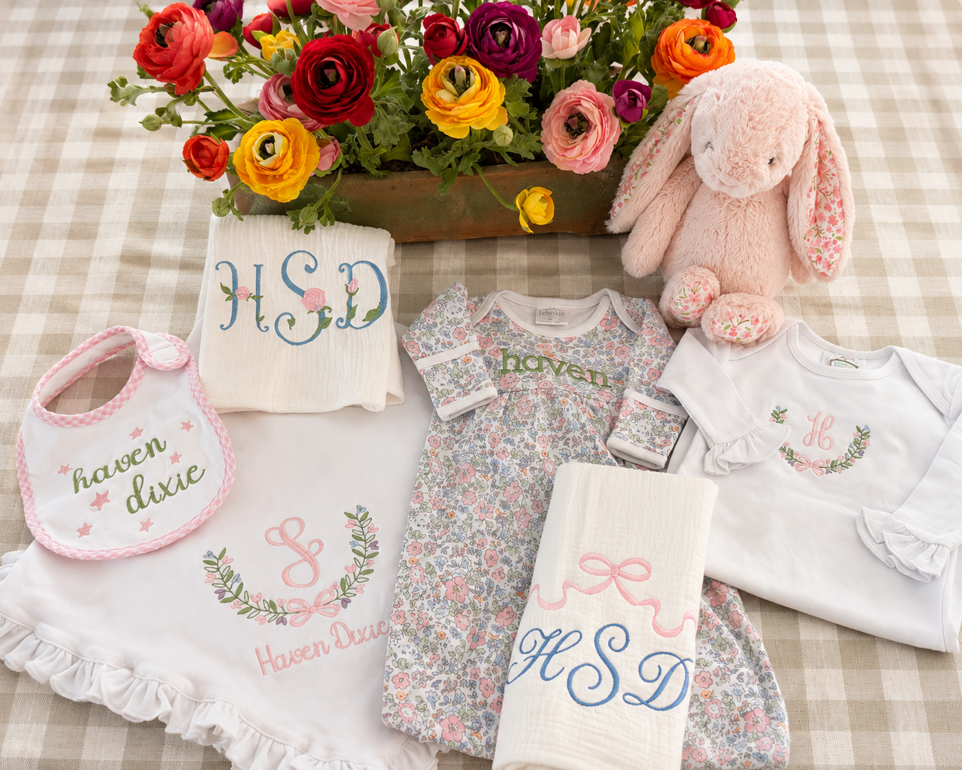Personalized embroidered baby gifts styled on neutral gingham